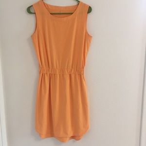 Athlete sleeveless peach/orange dress.